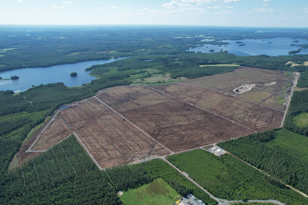 Aerial view of Hallanvahti solar park site, 200+ hectares of cleared peat ground beside Saimaa lake system