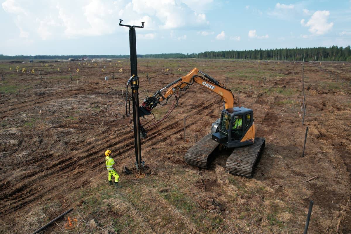 Helicasol crew installing a helical pile, Case excavator with rotary drive head, Hallanvahti