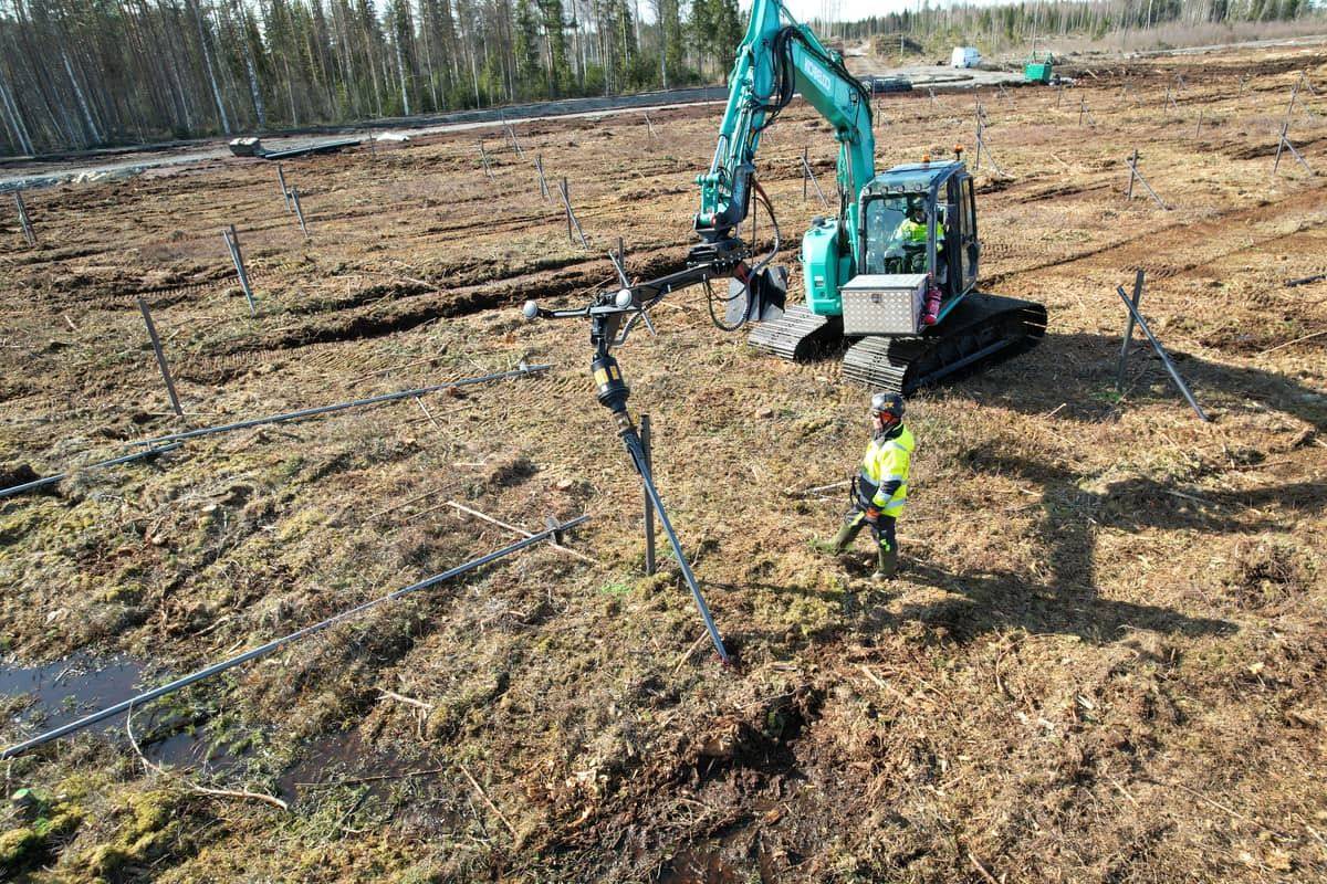 Drone view of Kobelco rig and worker mid-install, Hallanvahti