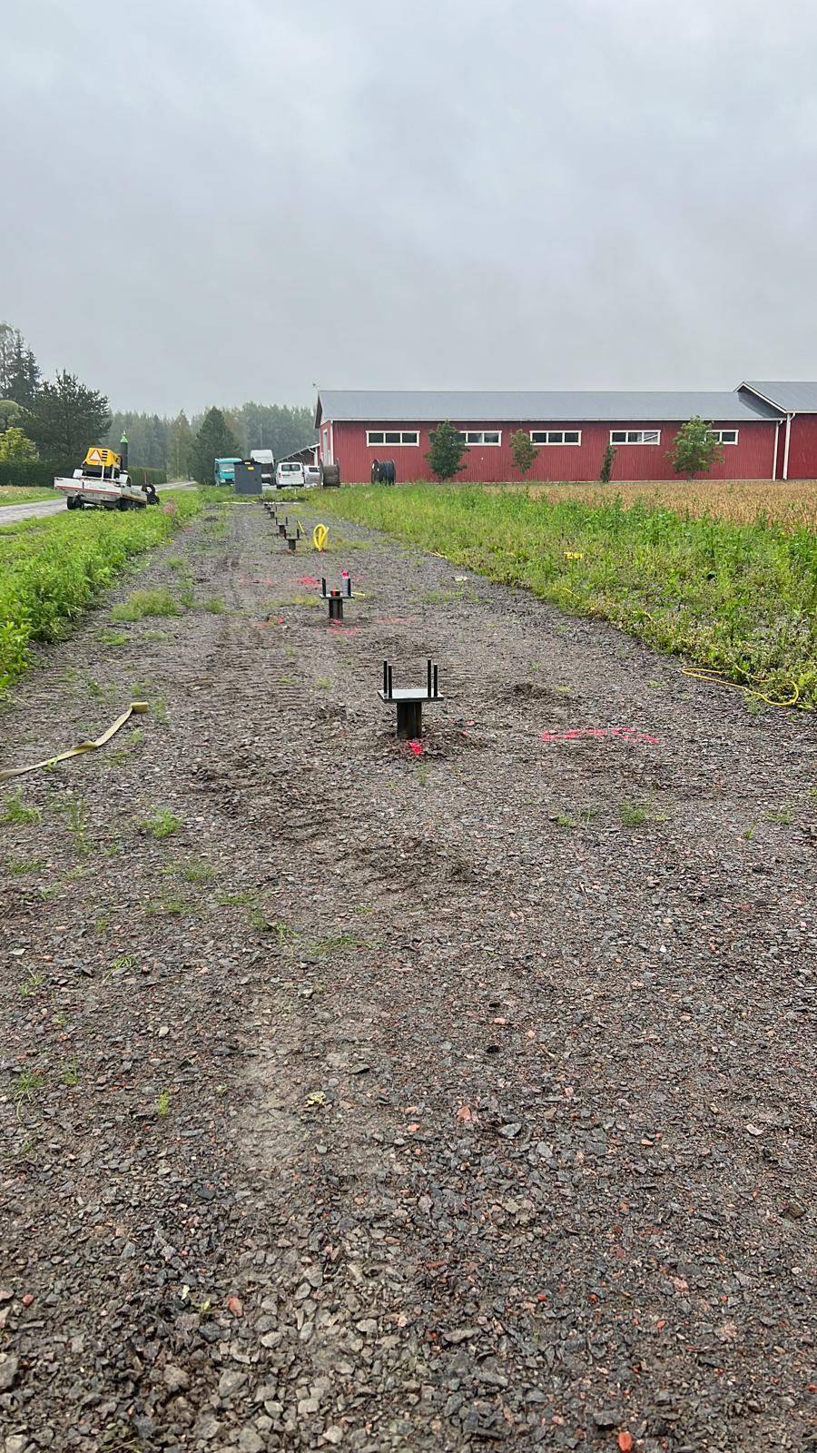 Helical-pile caps installed in line, ready for tracker columns &mdash; Ypäjä, Finland