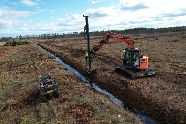 Aerial view of a cleared solar site with the installation rig and ATV — the planner's perspective on site data