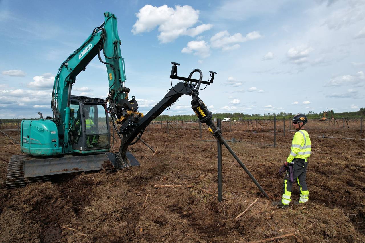 Helicasol crew installing helical piles with Kobelco excavator and rotary head