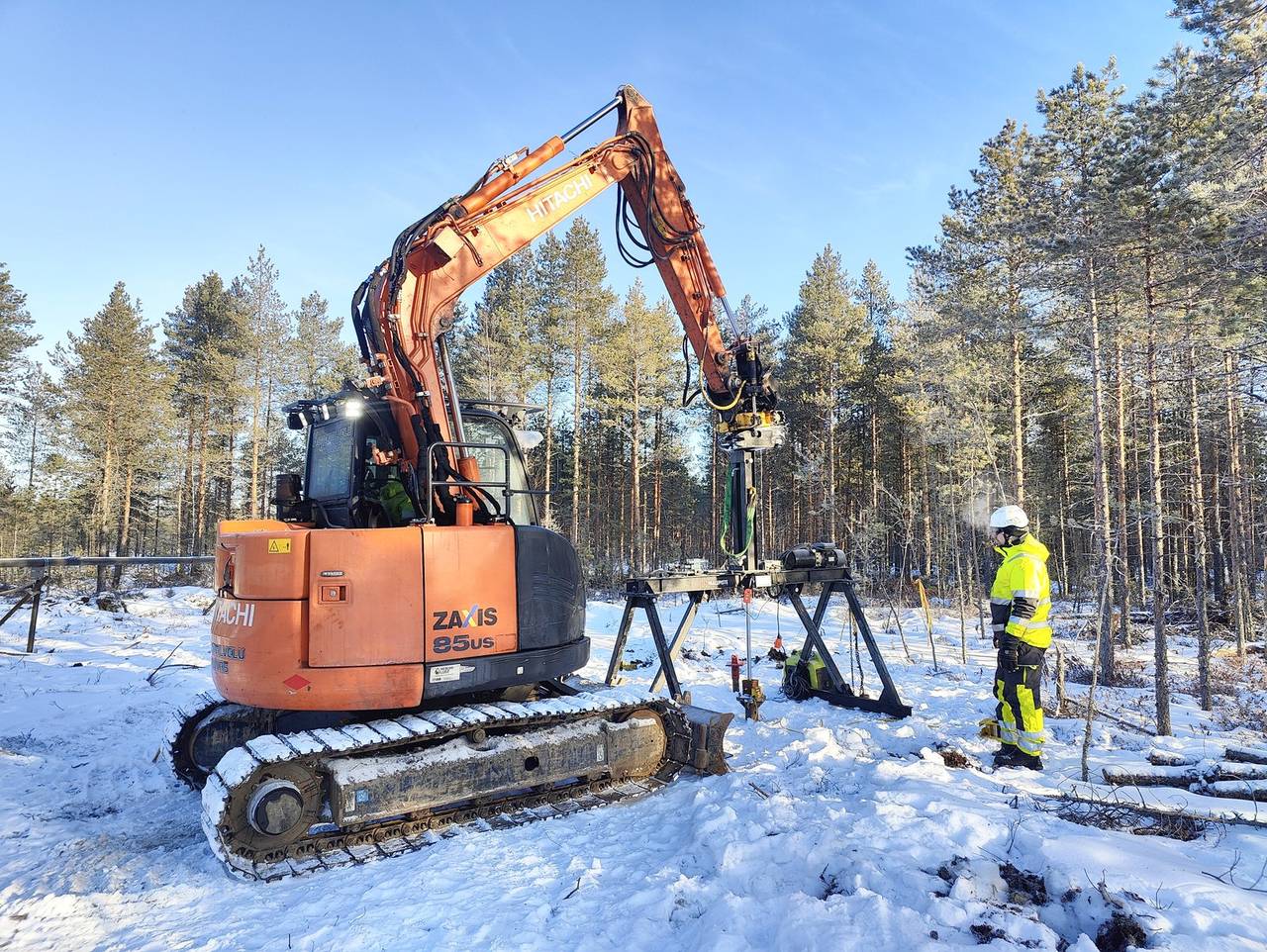 Helicasol reference pile installation in Finnish winter — Hitachi excavator with helical pile rig